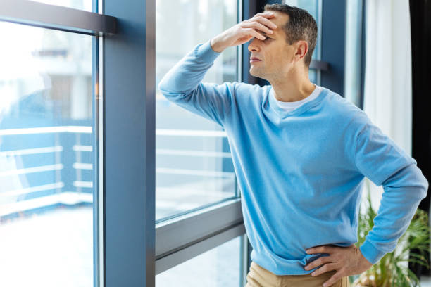 istock Sad moody man looking into the window 871517992