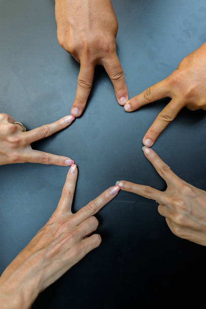 istock Hands joining together to form a five-pointed star 871518432