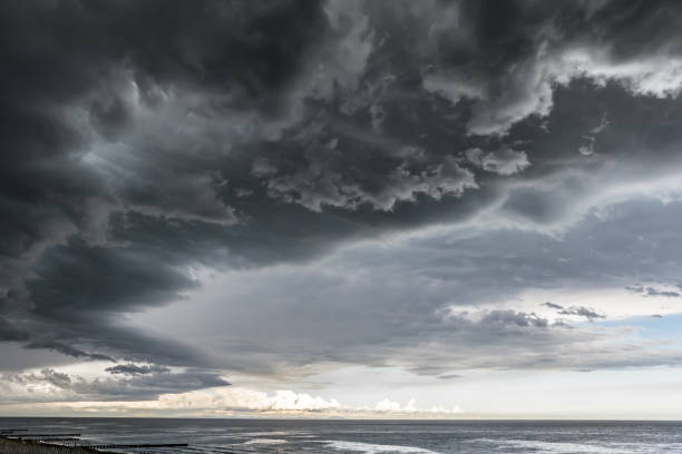 approaching storm cloud with rain over the sea - storm cloud storm dramatic sky hurricane imagens e fotografias de stock