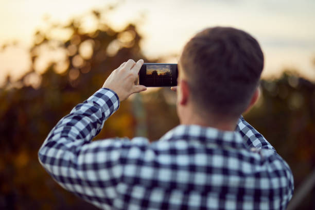 istock Man taking photo with digital camera on mobile phone 871523844