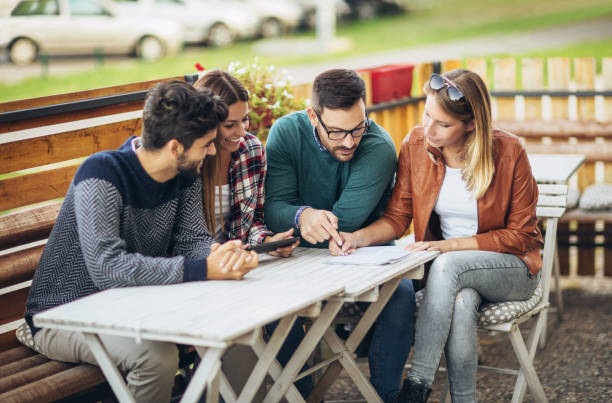 istock Group of four friends having fun a coffee together. 871524884