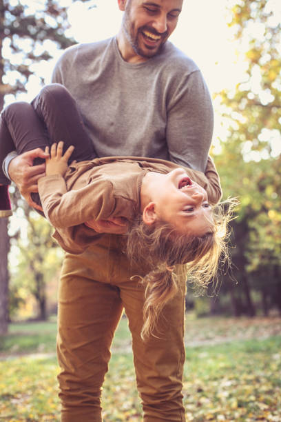 istock Father have play with daughter, carrying her in arms. 871525344