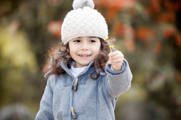 istock Little girl in autumn park 871525466