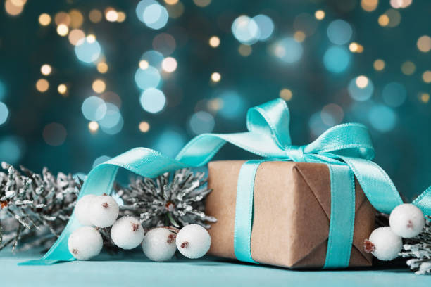 istock Magic christmas background with gift box and snowy fir tree. Greeting card with bokeh effect. 871525620