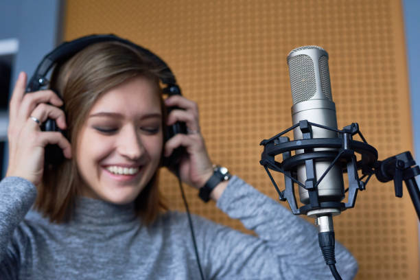 istock Joyful female singer preparing for recording 871525662