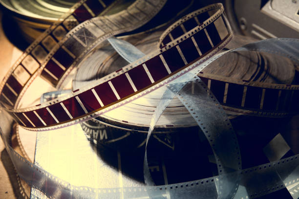 an old film with a movie on the roll. - conveyor belt fotos imagens e fotografias de stock