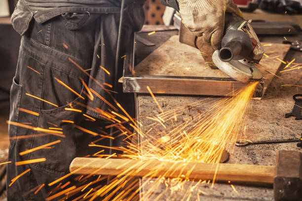 istock close up grinds a metal product with angle grinder 871532904