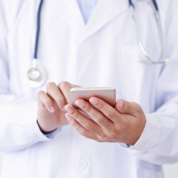 istock Doctor hands with smartphone 871536326