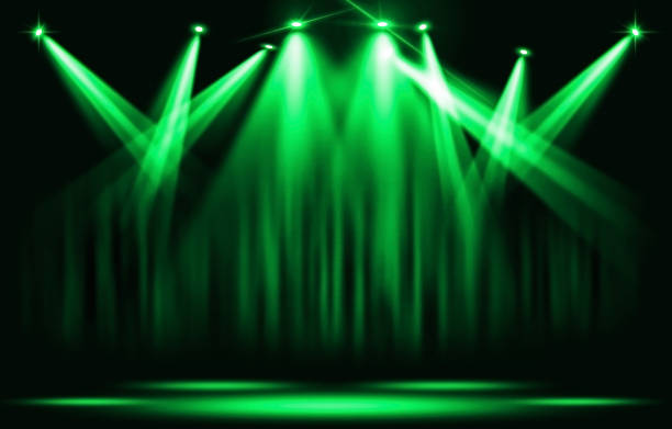 istock Stage lights. Green spotlight with certain through the darkness. 871537388