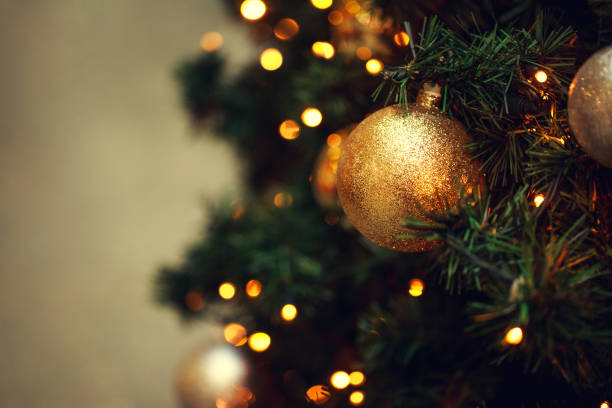 istock Fir branch with balls and festive lights 871543296