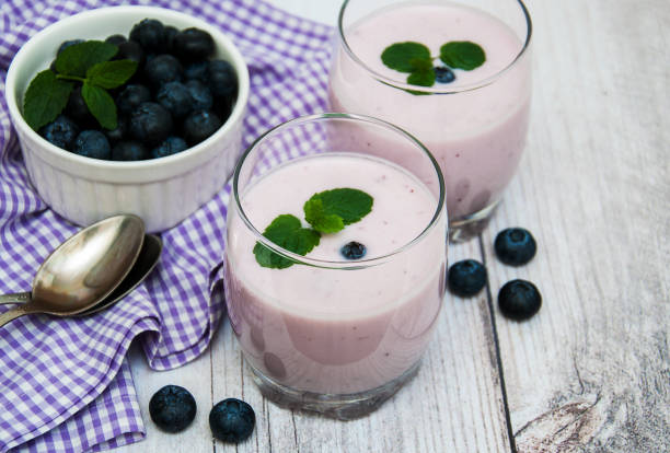 istock Glasses with blueberry yogurt on a table 871544840