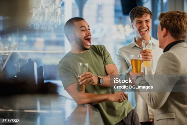 Enjoying Drinks After Work Stock Photo - Download Image Now - Friendship, Beer - Alcohol, Bar - Drink Establishment