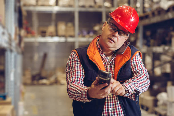 istock Man with clipboard and smartphone at warehouse 871549830