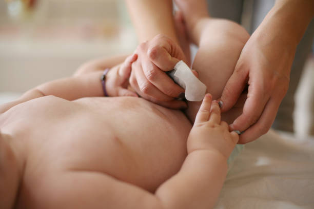 istock Mother changing her baby boy. Close up. 871550518
