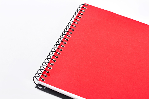 Red notepad on white background. Red notebook or writing pad isolated on white background. Craft paper notebook.