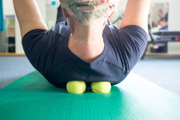 istock A woman practicing self-massage technique with tennis ball 871553202