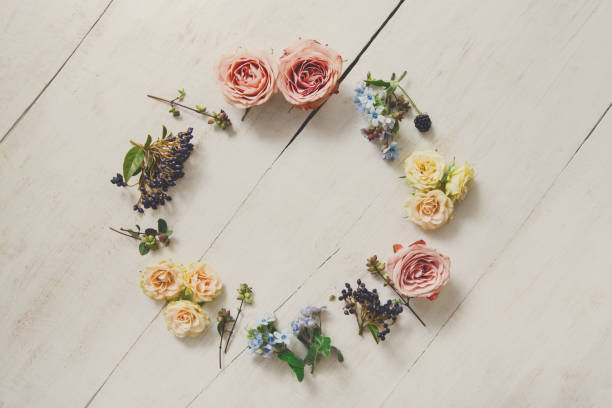 istock Flowers circle on white wood, top view 871554216