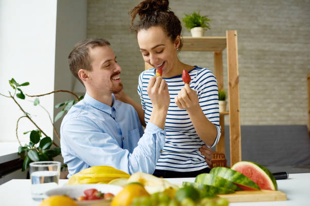 istock Happy couple eating strawberry together 871554312