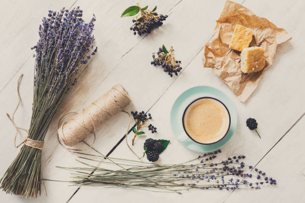 istock Latte coffee and flowers composition on white wood 871554410