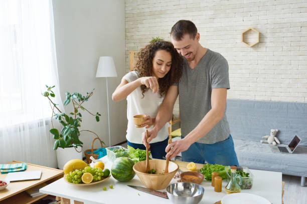 istock Cheerful young couple creating healthy dish 871554784