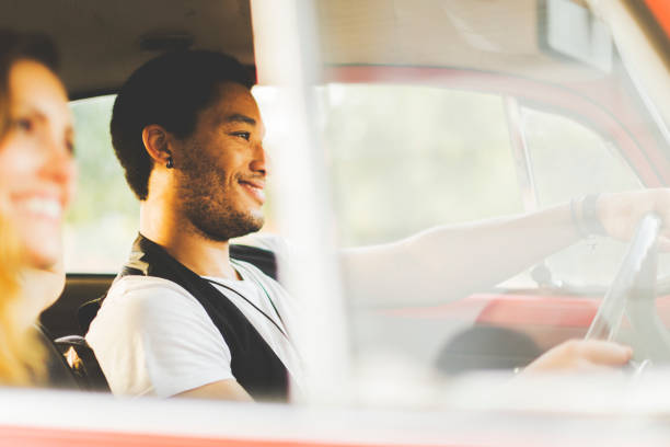 istock Diversity: multiethnic couple in a red vintage car 871554814