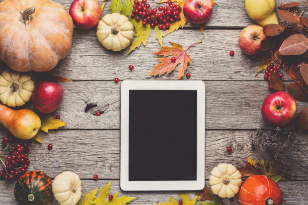 istock Seasonal background with autumn harvest and tablet 871554882