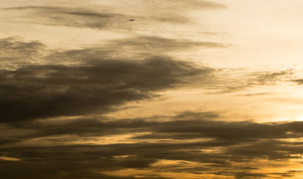 istock Sunset over Bangkok - Golden sky with plane 871554992