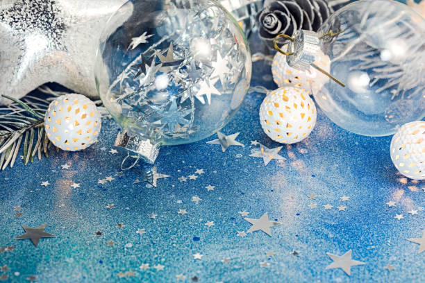istock blue glitter background with sparkling confetti and different christmas tree decorations 871558150