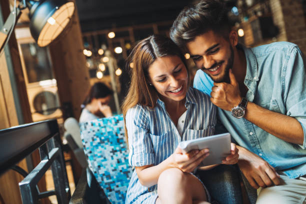 istock Young attractive couple on date in coffee shop 871564880