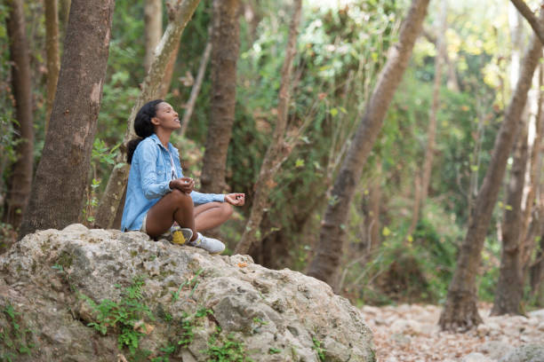istock Young woman outdoor meditating. 871565690