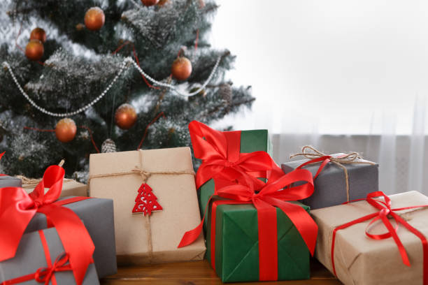 istock Christmas present on decorated tree background, holiday concept 871566534