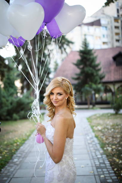 istock Beautiful bride with balloons outdoors 871570032