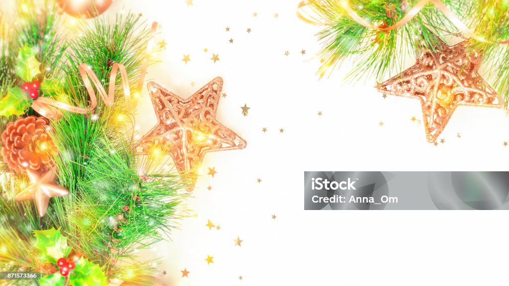 Christmas decorative border Christmas decorative border over white background, beautiful festive winter holidays ornament, golden toys on the evergreen tree branch, photo with copyspace, happy winter holidays Berry Stock Photo