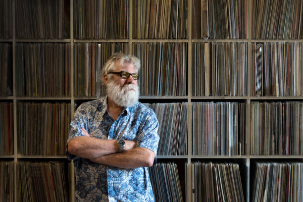 istock Record collector in front of his collection, looking away. 871574030