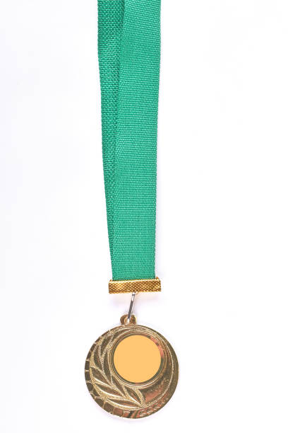 istock Golden medal hanging on green tape. 871574340
