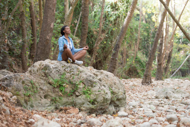 istock Young woman outdoor meditating. 871574630