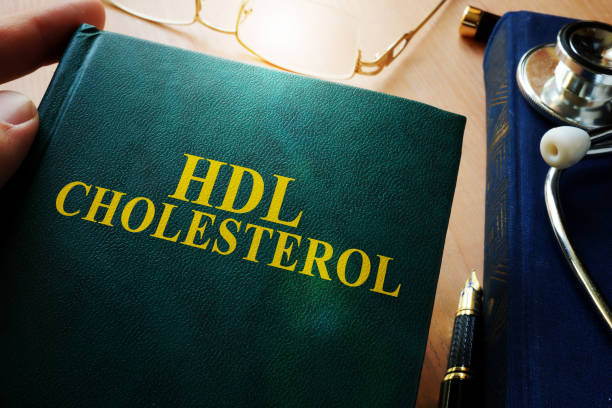 istock Man holding book about hdl cholesterol. 871577548
