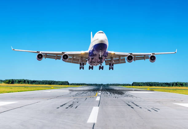 istock Passenger airplane landing at clear blue sky on a runway. 871578290
