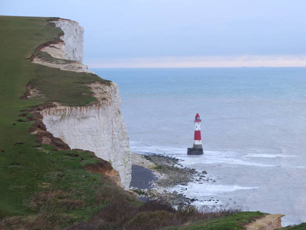 istock Chalk cliffs and Lighthouse at ocean coastline in England 871581152