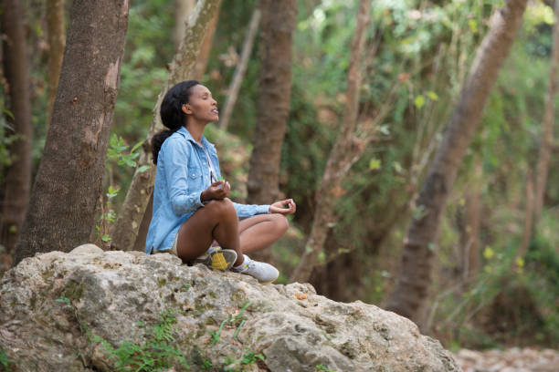 istock Young woman outdoor meditating. 871581668