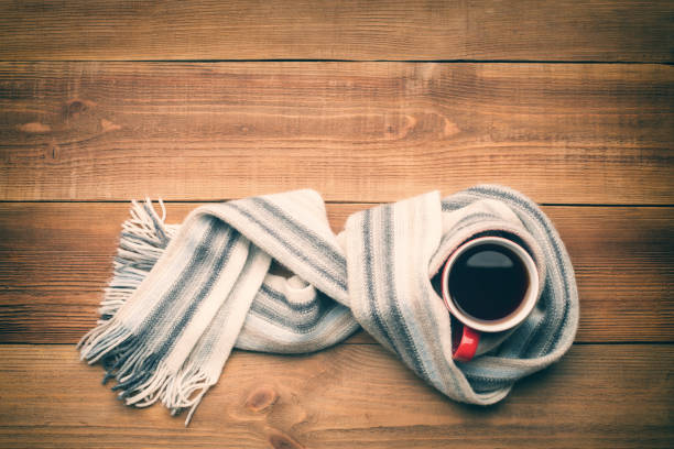 istock A cup of hot tea is wrapped in a scarf. 871582012