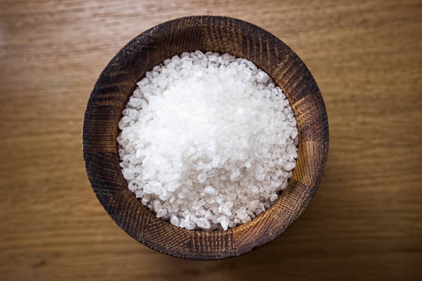 istock Sea salt in a wooden salt shaker. 871582132