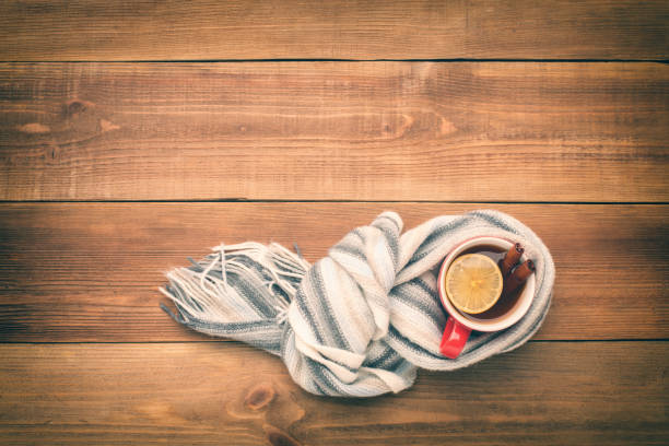 istock A cup of hot tea is wrapped in a scarf. 871584716