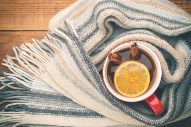 istock A cup of hot tea is wrapped in a scarf. 871585104