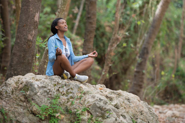 istock Young woman outdoor meditating. 871588850