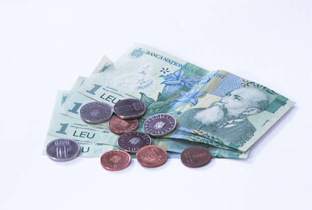 istock Four banknotes worth  1 Romanian Leu with several coins worth 10 and 5 Romanian Bani isolated on a white background 871589206