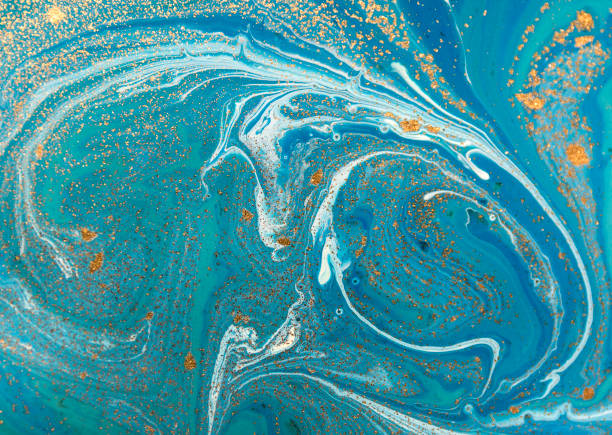 istock Marbled blue abstract background with golden sequins. Liquid marble ink pattern. 871589778