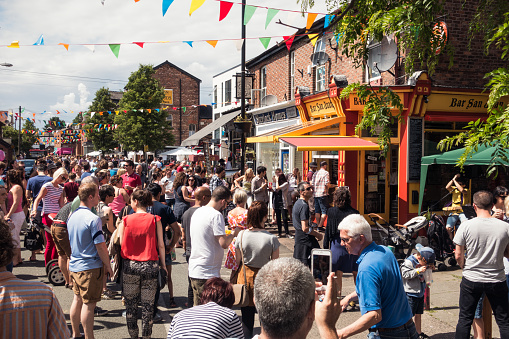 Manchester, UK - People enjoying warm weekend weather in the Manchester suburb of Chorlton during a community street festival.