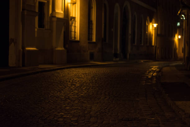 istock cobbled street in old city by night 871601258