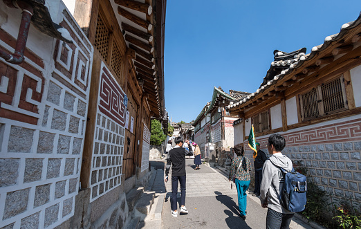 Tourists walking the narrow Streets and old roofs of of Bukchon Hanok Village